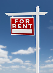 Image showing Left Facing For Rent Real Estate Sign on a Blue Sky with Clouds.