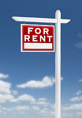 Image showing Left Facing For Rent Real Estate Sign on a Blue Sky with Clouds.