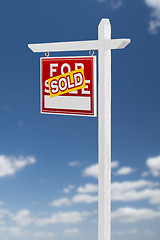 Image showing Left Facing Sold For Sale Real Estate Sign on a Blue Sky with Cl