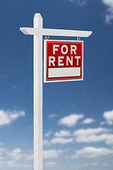 Image showing Right Facing For Rent Real Estate Sign on a Blue Sky with Clouds