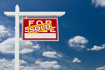 Image showing Right Facing Sold For Sale Real Estate Sign Over Blue Sky and Cl