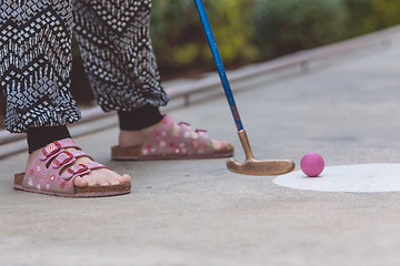 Image showing Happy little girl  playing mini golf.