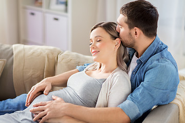 Image showing man hugging pregnant woman at home