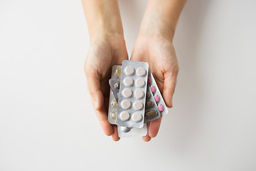 Image showing woman hands holding packs of pills