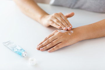 Image showing close up of hands with cream or therapeutic salve