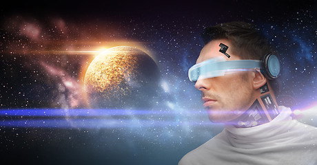 Image showing male robot in 3d glasses and sensors over space