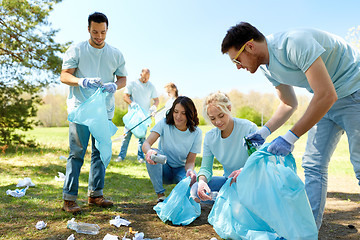 Image showing volunteers with garbage bags cleaning park area