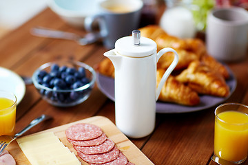 Image showing coffee pot and food on served table at breakfast