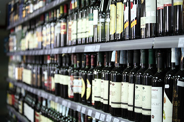 Image showing Wine bottles in a row, selective focus