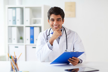 Image showing happy doctor with clipboard at clinic