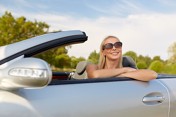 Image showing happy young woman in convertible car