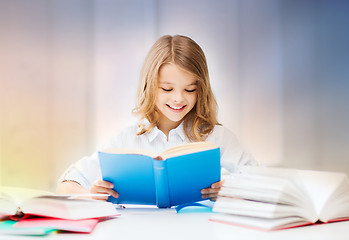 Image showing happy smiling student girl reading book