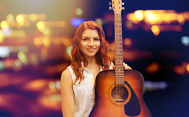 Image showing female musician with guitar over night city lights