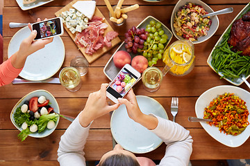 Image showing people with smartphones photographing food