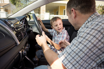 Image showing Happy father and son sitting in the car at the day time.