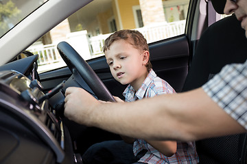 Image showing Happy father and son sitting in the car at the day time.