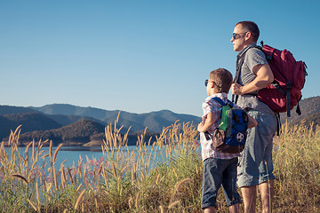 Image showing Happy family standing near the lake at the day time.