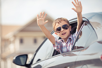 Image showing One happy little boy sitting in the car.