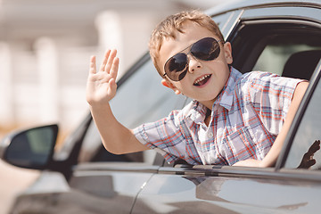 Image showing One happy little boy sitting in the car.