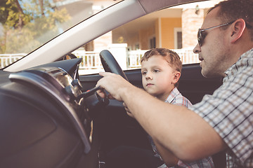 Image showing Happy father and son sitting in the car at the day time.