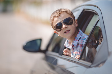 Image showing One happy little boy sitting in the car.