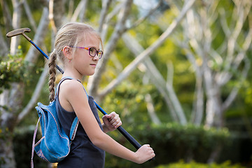 Image showing Happy little girl  playing mini golf.