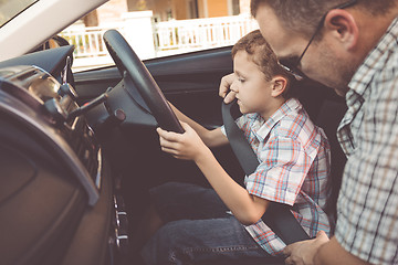 Image showing Happy father and son sitting in the car at the day time.