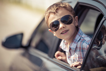 Image showing One happy little boy sitting in the car.