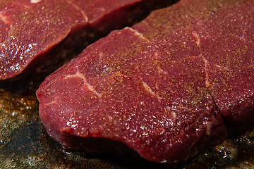 Image showing A juicy steak seasoned with pepper ready to be fried