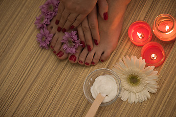 Image showing female feet and hands at spa salon