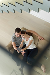 Image showing couple relaxing at  home with tablet computers