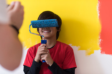 Image showing young boy painter with paint roller