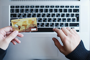 Image showing Woman using credit card for online purchase