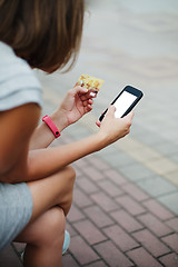 Image showing Woman using phone and card for shopping