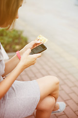 Image showing Woman using phone and card for shopping