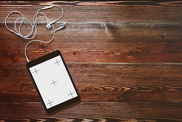 Image showing Digital tablet computeron old wooden desk.