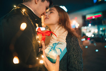 Image showing romantic surprise for Christmas, woman receives a gift from her boyfriend