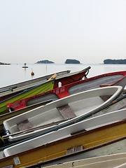 Image showing A stack of boats on a shore