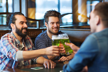 Image showing male friends drinking green beer at bar or pub