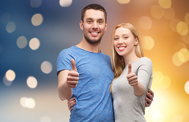 Image showing happy couple hugging and showing thumbs up