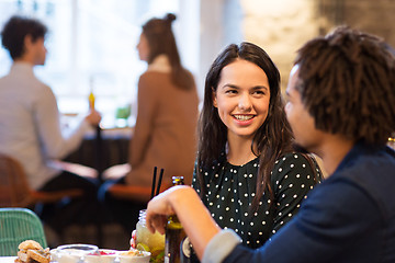 Image showing happy couple with drinks at restaurant or bar