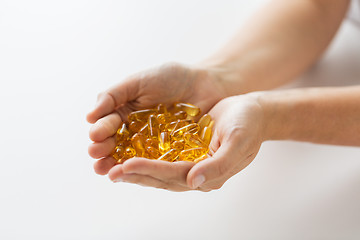 Image showing hands holding cod liver oil capsules