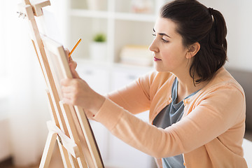 Image showing artist with pencil drawing picture at art studio