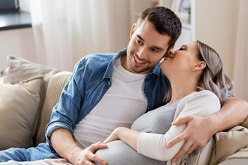 Image showing man hugging pregnant woman at home