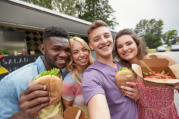 Image showing happy friends taking selfie at food truck