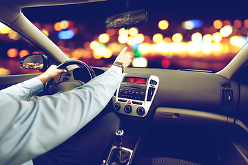 Image showing close up of man driving car and pointing finger