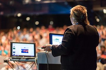 Image showing Female public speaker giving talk at Business Event.