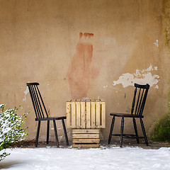 Image showing table and two chairs near the wall