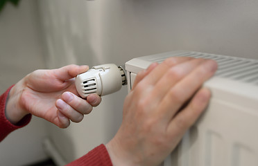 Image showing Woman Adjusting Thermostat