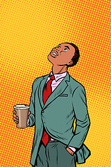 Image showing African businessman drinking coffee and looking up